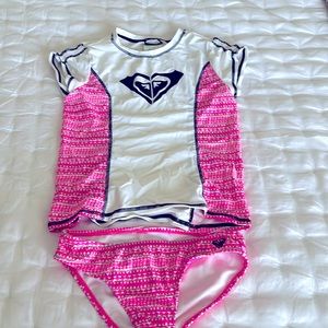 Pink patterned and white Roxy swim set with swim shirt and matching bottoms